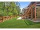 Expansive backyard features a well-manicured lawn, wood fence, and direct access to the deck above at 410 Crestbrook Ln, Dallas, GA 30157