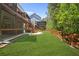Beautiful backyard with lush lawn, wood fence, access to screened porch, and deck area at 410 Crestbrook Ln, Dallas, GA 30157