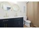 Modern bathroom with double sinks, dark blue cabinets, white countertops, and stylish gold hardware at 410 Crestbrook Ln, Dallas, GA 30157