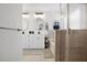 Bright bathroom with double vanity, soaking tub, open shelving, and glass enclosed tiled shower at 410 Crestbrook Ln, Dallas, GA 30157