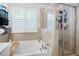 Bathroom featuring a shower with glass enclosure, a large tub, and stylish tile work, and a window at 410 Crestbrook Ln, Dallas, GA 30157