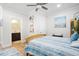Bright bedroom featuring a wooden bed frame, light walls, and doorway to an attached bathroom at 410 Crestbrook Ln, Dallas, GA 30157