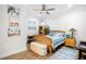 Charming bedroom with wooden furniture, beach artwork, ceiling fan, and bright, natural light at 410 Crestbrook Ln, Dallas, GA 30157