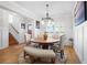 Well-lit dining area featuring wainscoting, hardwood floors, a round wooden table, and seating for Gathering meals at 410 Crestbrook Ln, Dallas, GA 30157