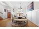 Spacious dining room enhanced by wainscoting, hardwood floors, a round table, and stylish seating for an inviting feel at 410 Crestbrook Ln, Dallas, GA 30157