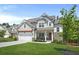 Beautiful two-story home with a well-kept lawn, a pergola, and a welcoming front porch in a suburban setting at 410 Crestbrook Ln, Dallas, GA 30157