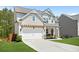 Attractive two-story home with a pergola over the garage and a manicured lawn, nestled in a suburban landscape at 410 Crestbrook Ln, Dallas, GA 30157