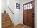 An inviting foyer with hardwood floors, wooden stairs, and a door with glass panes for natural light at 410 Crestbrook Ln, Dallas, GA 30157