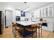 Modern kitchen featuring a center island with seating, white cabinets, quartz countertops, and stainless steel appliances at 410 Crestbrook Ln, Dallas, GA 30157