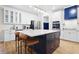 Modern kitchen featuring white cabinets, stainless steel appliances, a large island and hardwood floors at 410 Crestbrook Ln, Dallas, GA 30157