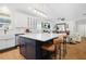 Open kitchen with eat-in island and seating area featuring open floor plan and hardwood flooring at 410 Crestbrook Ln, Dallas, GA 30157