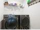 Laundry room featuring front load washer and dryer and storage shelving at 410 Crestbrook Ln, Dallas, GA 30157