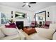 Cozy living area with a fireplace, hardwood floors, comfortable seating, and natural light from multiple windows at 410 Crestbrook Ln, Dallas, GA 30157