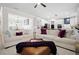 Open-concept living room connected to the kitchen, featuring hardwood floors, plush sofas, and contemporary design at 410 Crestbrook Ln, Dallas, GA 30157