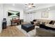 Spacious living room featuring a large sectional, workspace, mounted television, and sliding barn door at 410 Crestbrook Ln, Dallas, GA 30157