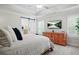 Serene main bedroom with tray ceilings, a wooden dresser, and a relaxing view on the television at 410 Crestbrook Ln, Dallas, GA 30157