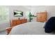 Bright main bedroom features a light wood dresser, wardrobe, television, and comfortable bed with natural light at 410 Crestbrook Ln, Dallas, GA 30157
