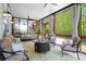 Inviting screened patio with ceiling fans, swing, comfortable seating, and backyard views at 410 Crestbrook Ln, Dallas, GA 30157