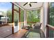Relaxing screened porch featuring neutral furniture, curtains for privacy, and a scenic view at 410 Crestbrook Ln, Dallas, GA 30157