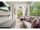 Inviting screened porch with comfortable seating, an outdoor TV, and a view of the surrounding woods at 410 Crestbrook Ln, Dallas, GA 30157