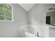 Bathroom featuring a corner tub with tile surround, and a window at 7117 Stonebrook Cv, Lithonia, GA 30058
