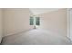 Neutral bedroom with vaulted ceiling, carpeted floor, and large windows at 7117 Stonebrook Cv, Lithonia, GA 30058