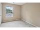 Cozy bedroom with plush carpeting and a window offering natural light at 7117 Stonebrook Cv, Lithonia, GA 30058