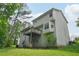 Exterior of the house shows a spacious backyard with a deck, windows, and light siding, providing a charming view at 7117 Stonebrook Cv, Lithonia, GA 30058