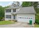 Charming two-story home featuring a classic colonial design and an attached two-car garage at 7117 Stonebrook Cv, Lithonia, GA 30058