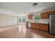 Bright kitchen area featuring stainless steel appliances, wood cabinets, and adjacent dining space at 7117 Stonebrook Cv, Lithonia, GA 30058