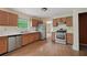 Well-lit kitchen with stainless steel appliances, wood cabinets, and light countertops at 7117 Stonebrook Cv, Lithonia, GA 30058