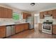 Well-lit kitchen with stainless steel appliances, wood cabinets, and light countertops at 7117 Stonebrook Cv, Lithonia, GA 30058