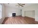 Bright living room featuring hardwood floors, a cozy fireplace, and large windows at 7117 Stonebrook Cv, Lithonia, GA 30058