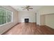 Bright living room featuring hardwood floors, a cozy fireplace, and large windows at 7117 Stonebrook Cv, Lithonia, GA 30058