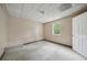 Bedroom featuring window, closet door, and carpeted flooring, perfect for renovation and customization at 7117 Stonebrook Cv, Lithonia, GA 30058