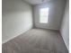 Cozy bedroom featuring neutral carpet and one window at 1529 Iris Walk, Jonesboro, GA 30238