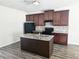 Modern kitchen with stainless steel appliances, granite countertops, and dark wood cabinets at 1529 Iris Walk, Jonesboro, GA 30238