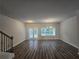 Open concept living room with wood floors, plenty of natural light, and stylish light fixtures at 1529 Iris Walk, Jonesboro, GA 30238