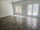 Bright living area with wood floors, large windows, and a door leading to the backyard at 1529 Iris Walk, Jonesboro, GA 30238