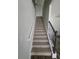 Carpeted staircase with decorative black iron railings, leading to the upper level of the home at 1529 Iris Walk, Jonesboro, GA 30238
