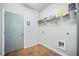 Laundry room with gray walls, tiled floors, storage shelf, and utility hookups at 1657 Preserve Park Dr, Loganville, GA 30052