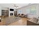 Bright living room with fireplace, hardwood floors, ceiling fan and large windows for natural light at 1657 Preserve Park Dr, Loganville, GA 30052