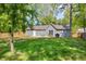 Lush backyard showcasing mature trees, green lawn, and a newly built patio at 1660 Rose Garden Ln, Loganville, GA 30052