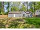 Large backyard with a patio area and grass, ideal for entertaining and outdoor living at 1660 Rose Garden Ln, Loganville, GA 30052