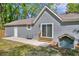 Side view of the home and concrete patio in backyard at 1660 Rose Garden Ln, Loganville, GA 30052