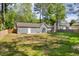 Spacious backyard featuring a patio area, wooden fence, and ample green space at 1660 Rose Garden Ln, Loganville, GA 30052