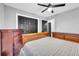 Bedroom features black closet doors, dark wood floors, and a ceiling fan at 1660 Rose Garden Ln, Loganville, GA 30052