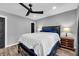 This bedroom offers a ceiling fan, grey walls, and wood-look flooring at 1660 Rose Garden Ln, Loganville, GA 30052