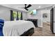 This bedroom offers a ceiling fan, tv, grey walls, and wood-look flooring at 1660 Rose Garden Ln, Loganville, GA 30052