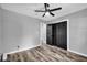 This bedroom features dark wood floors and a modern ceiling fan at 1660 Rose Garden Ln, Loganville, GA 30052